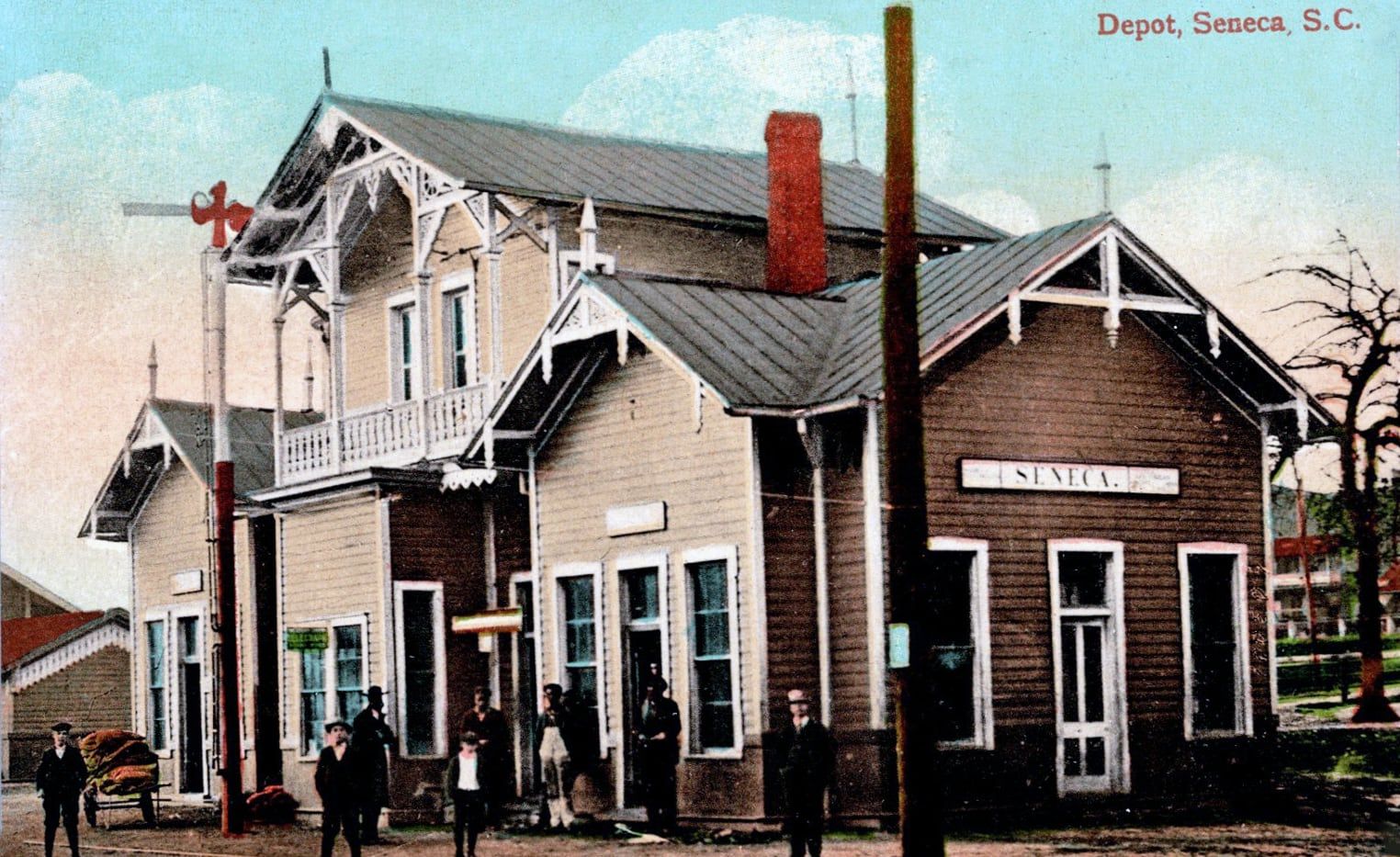 A tinted postcard of the old Seneca railroad depot, about 1908, with people on the platform
